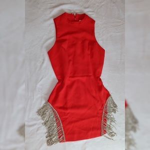 Dress featuring side slits wit rhinestone fringe.